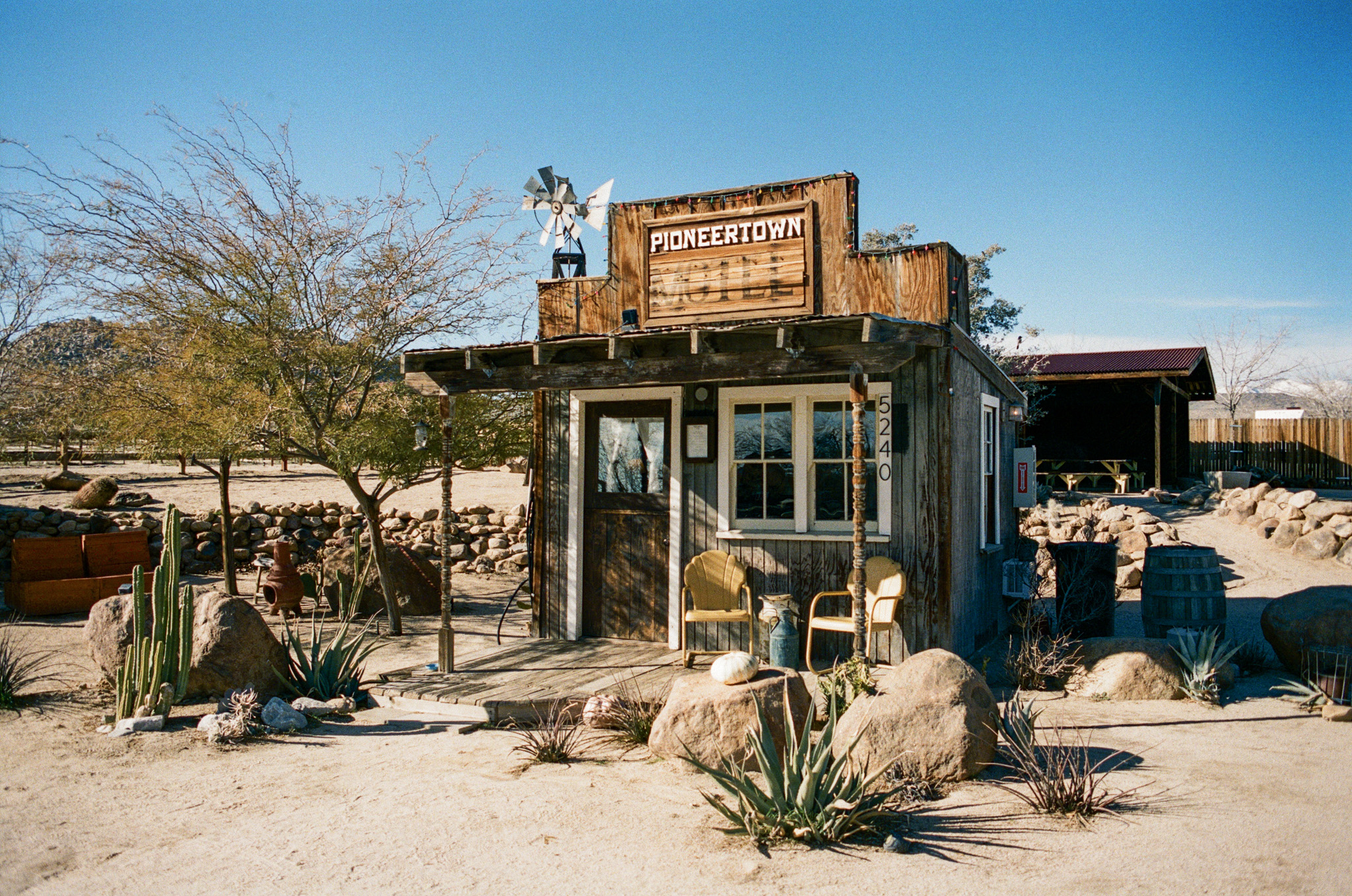 A little wooden building with a sign that says Pioneertown Motel.