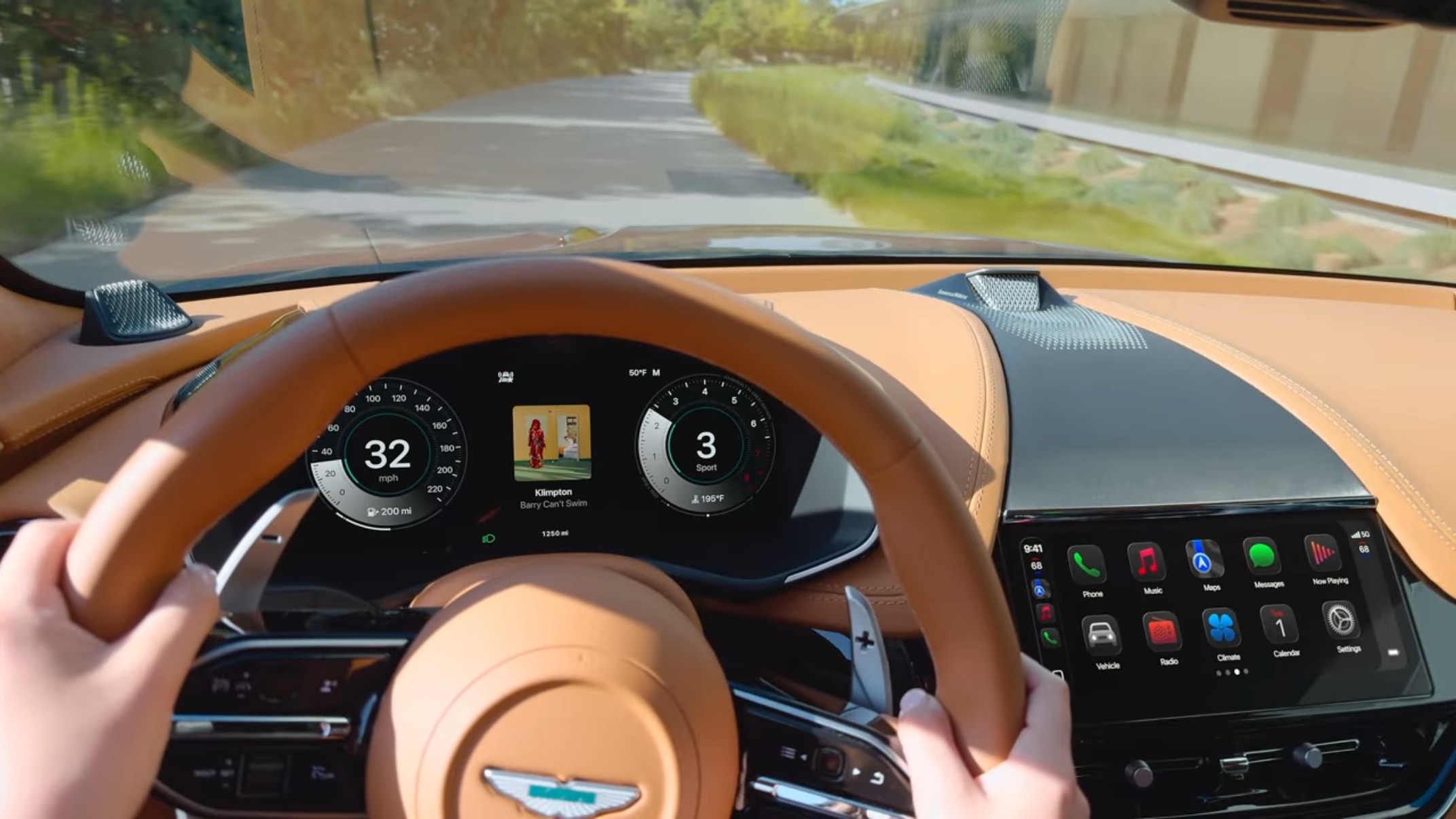 A screenshot from an Aston Martin showing the instrument cluster and the center stack in CarPlay Ultra with the center having the liquid bevel look and the instrument cluster having the previous flat look.