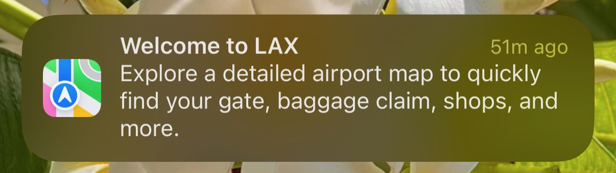 Screenshot of an iOS notification. 'Welcome to LAX. Explore a detailed airport map to quickly find your gate, baggage claim, shops, and more.