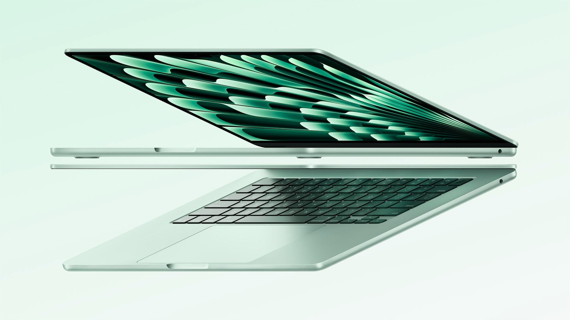 Product photography of the M4 MacBook Air with the lid slightly open. It's all very subtly greenish silver on a greenish white background.